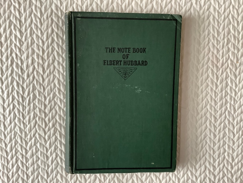 May include: A green hardcover book with the title "The Note Book of Elbert Hubbard" printed on the front cover.
