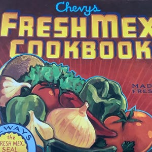 May include: A red and yellow cookbook cover with the title "Chevys Fresh Mex Cookbook" and the words "Made Fresh" in white text. The cover features a colorful illustration of vegetables and peppers in a cornucopia.