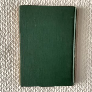 May include: A dark green hardcover book with a plain cover.