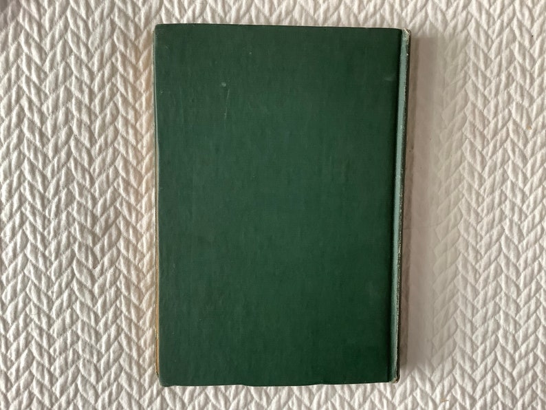 May include: A dark green hardcover book with a plain cover.