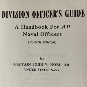 May include: A book titled "Division Officer's Guide: A Handbook For All Naval Officers (Fourth Edition)" by Captain John V. Noel, Jr., United States Navy.