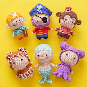 May include: A set of six crocheted stuffed toys, including a pirate, a monkey, a mermaid, an octopus, and two other characters. The toys are all brightly coloured and have friendly faces.