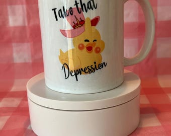 May include: White ceramic mug with a yellow chick wearing a pink hat and the text "Take that Depression".