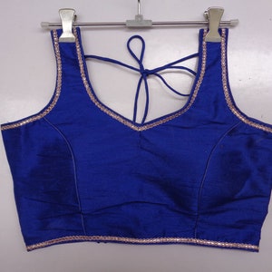 royal blue color dupin readymade saree blouse with designer trim . sleeveless padded blouse , comfortable blouse . saree blouse for women.
