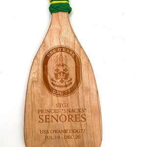 Military paddle made of top grade cherry wood with custom laser engraving.  Navy, USCG, Marines, Air Force, Army, Joint Chiefs, any logo you would like.  Price includes all front side engraving and paracord wrap plus free shipping.