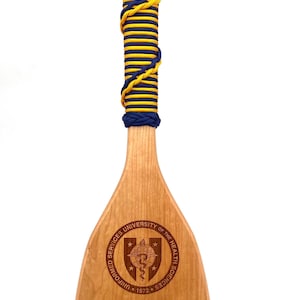 Military paddle made of top grade cherry wood with custom laser engraving.  Navy, USCG, Marines, Air Force, Army, Joint Chiefs, any logo you would like.  Price includes all front side engraving and paracord wrap plus free shipping.