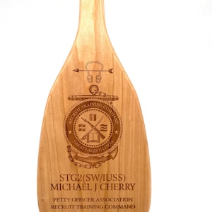 We will engrave anything you would like on our solid cherry wood paddle. We will design it for you.