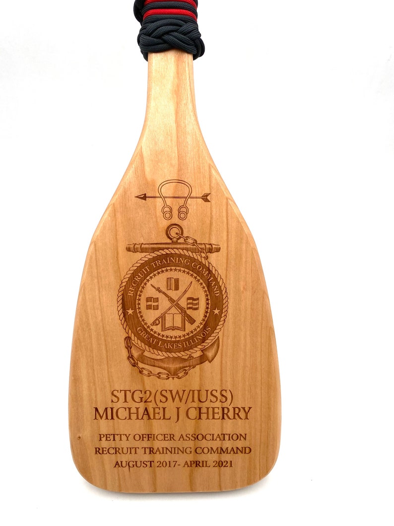 We will engrave anything you would like on our solid cherry wood paddle. We will design it for you.