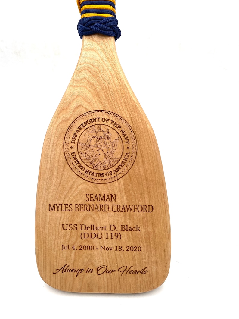 Military paddle made of top grade cherry wood with custom laser engraving.  Navy, USCG, Marines, Air Force, Army, Joint Chiefs, any logo you would like.  Price includes all front side engraving and paracord wrap plus free shipping.