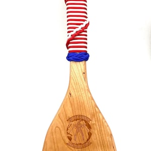 Military paddle made of top grade cherry wood with custom laser engraving.  Navy, USCG, Marines, Air Force, Army, Joint Chiefs, any logo you would like.  Price includes all front side engraving and paracord wrap plus free shipping.