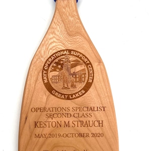 Military paddle made of top grade cherry wood with custom laser engraving.  Navy, USCG, Marines, Air Force, Army, Joint Chiefs, any logo you would like.  Price includes all front side engraving and paracord wrap plus free shipping.