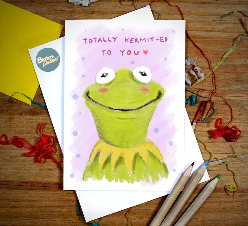 May include: A greeting card with a cartoon illustration of Kermit the Frog. The card has the text "Totally Kermit-ed to you" with a pink heart.
