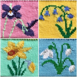 May include: Four knitted squares featuring different floral designs. The top left square is pink with a purple flower, the top right square is yellow with a green flower, the bottom left square is green with a yellow flower, and the bottom right square is blue with a white flower.