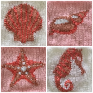 May include: A knitted square with four different sea-themed designs: a seashell, a starfish, a seashell, and a seahorse. The designs are knitted in coral and white yarn on a pink and white background.