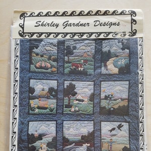 May include: A quilting pattern for a quilt titled "Story Book Farm" by Shirley Gardner Designs. The pattern features nine squares with different farm scenes, including a barn, a cow, a pig, a rooster, a farmhouse, a river, and a field of flowers.