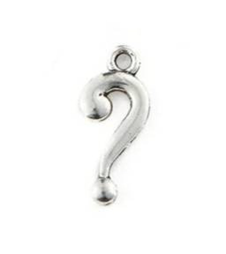 May include: Silver-toned question mark charm pendant. The charm is about 1 inch tall and has a loop at the top for attaching to a necklace or bracelet.