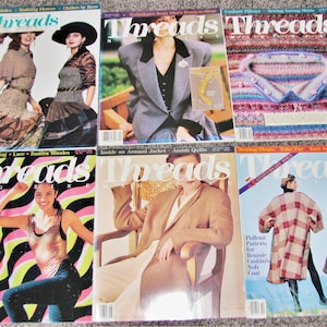 May include: Six issues of Threads magazine featuring various fashion and sewing topics. The covers feature models wearing different clothing styles, including a plaid coat, a striped dress, and a gray blazer. The magazine titles are visible on each cover.