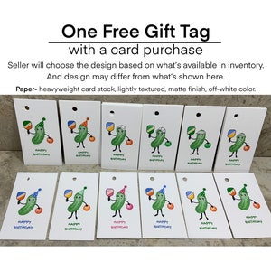 May include: Twelve white gift tags with a pickle character holding a paddle and wearing a party hat. The tags say "Happy Birthday".