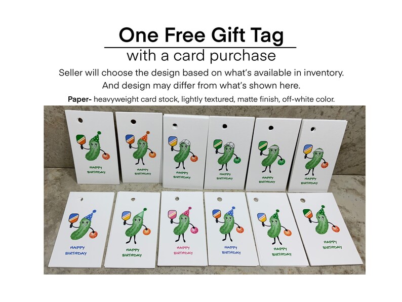 May include: Twelve white gift tags with a pickle character holding a paddle and wearing a party hat. The tags say "Happy Birthday".