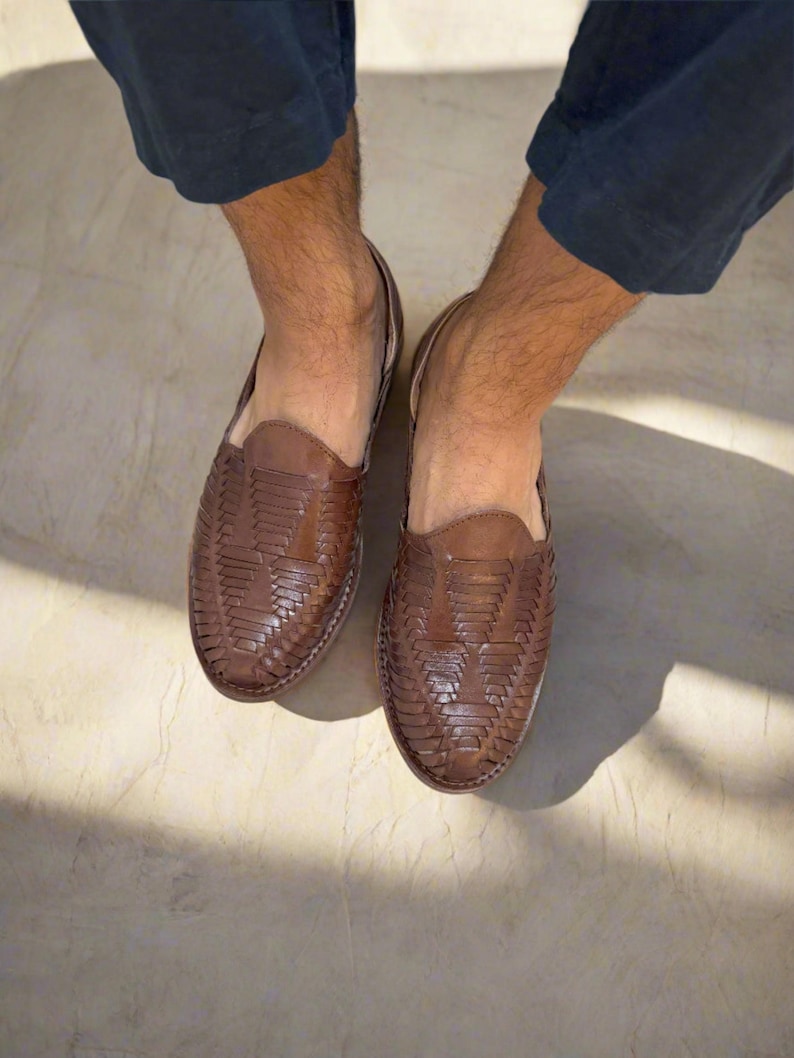 May include: A pair of brown leather woven slip-on shoes. The shoes have a woven pattern and a pointed toe.