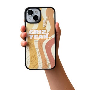 May include: A black phone case with a colorful retro design. The case features a saxophone illustration, musical notes, and the words "Griz, Yeah" in a bold font. The background has wavy stripes in shades of yellow, orange, and pink.