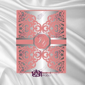 May include: A laser cut wedding invitation with a delicate floral design in silver on a coral background. The invitation features a monogram in a circle with the initials "JY".