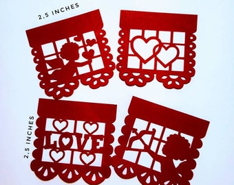 May include: Four red paper cut-out banners with Valentine's Day themes. Each banner measures 2.5 inches wide and features a different design: a cupid with an arrow, two intertwined hearts, the word "LOVE" with hearts, and a cupid with an arrow. The banners are designed for use as decorations or party favors.