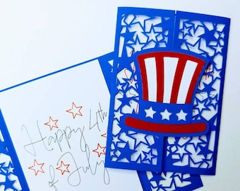 May include: A blue card with a red, white, and blue Uncle Sam hat cut out of the card. The card says "Happy 4th of July" in cursive.