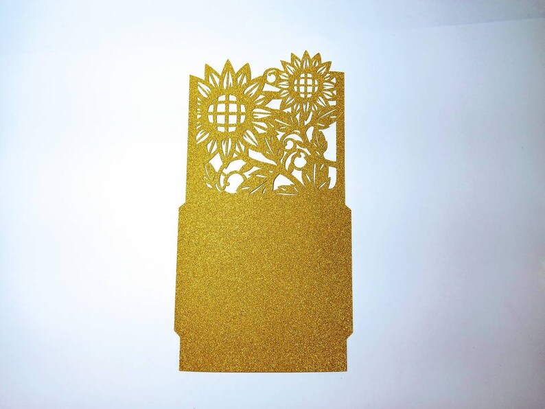 May include: Gold glitter card with a cut-out design of sunflowers and leaves.
