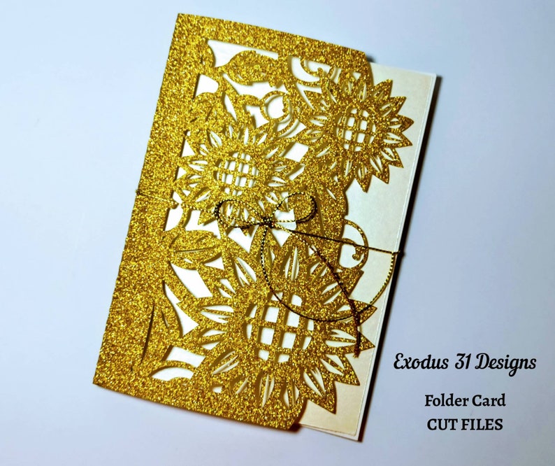 May include: Gold glitter folder card with a cut-out design of sunflowers. The card is folded in half and has a white interior. The text "Exodus 31 Designs" and "Folder Card CUT FILES" is printed on the front of the card.