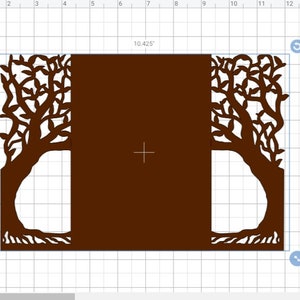 May include: A brown paper cut-out design featuring two trees with intricate branches and roots framing a central rectangular space. The design measures approximately 10.425 inches wide and 7.06 inches high, ideal for crafting projects.