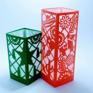 May include: Two paper lanterns, one green and one red, with intricate cut-out designs. The green lantern features a star design, while the red lantern has a floral and festive design.