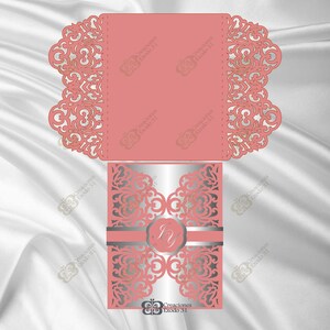May include: A laser cut wedding invitation with a pink and silver design. The invitation features a delicate floral pattern and a monogram in the center. The text "Creaciones Exodo 31" is printed on the bottom.