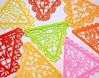 May include: A set of colourful paper cutouts in the shape of triangles with intricate designs. The cutouts are in shades of red, orange, yellow, green, and pink.