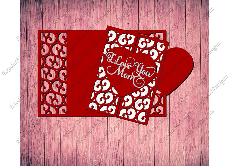 May include: Red and white paper card with a heart-shaped cutout. The heart has the words "I Love You Mom" inside. The card has a decorative border with a repeating pattern.