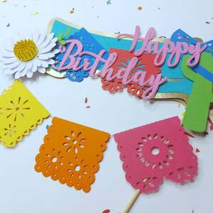 May include: A set of colorful paper decorations for a birthday party. The decorations include a banner that says "Happy Birthday", a cactus, a flower, and a string of paper flags.