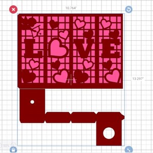 May include: A red and pink papercraft design with the word "LOVE" in large letters and a cupid with an arrow. The design is decorated with small hearts.