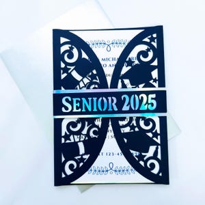May include: Black laser cut graduation invitation with a holographic blue and silver band that says "Senior 2025".