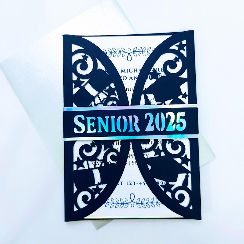 May include: Black laser cut graduation invitation with a holographic blue and silver band that says "Senior 2025".