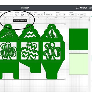 May include: A green, four-sided box with a shamrock design on each side. The box is 3.77 inches by 6.68 inches. The box is designed to be folded and assembled.