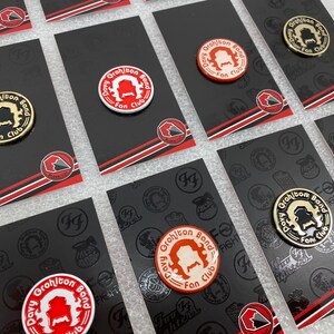May include: Multiple black and red cards with white and red pins featuring the text "Davy Grohl Band Fan Club" with a cartoon image of a person with a moustache.