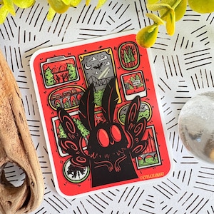 May include: A red sticker featuring a black moth-like creature with large eyes and wings. The sticker has several framed illustrations of landscapes and the text "LYDIAJEANART".