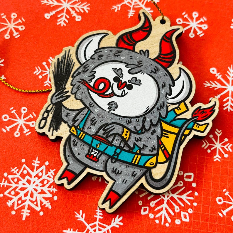 May include: A wooden Christmas ornament shaped like a gray monster with red horns, a red tongue, and a yellow and blue backpack. The monster is holding a black chimney brush.