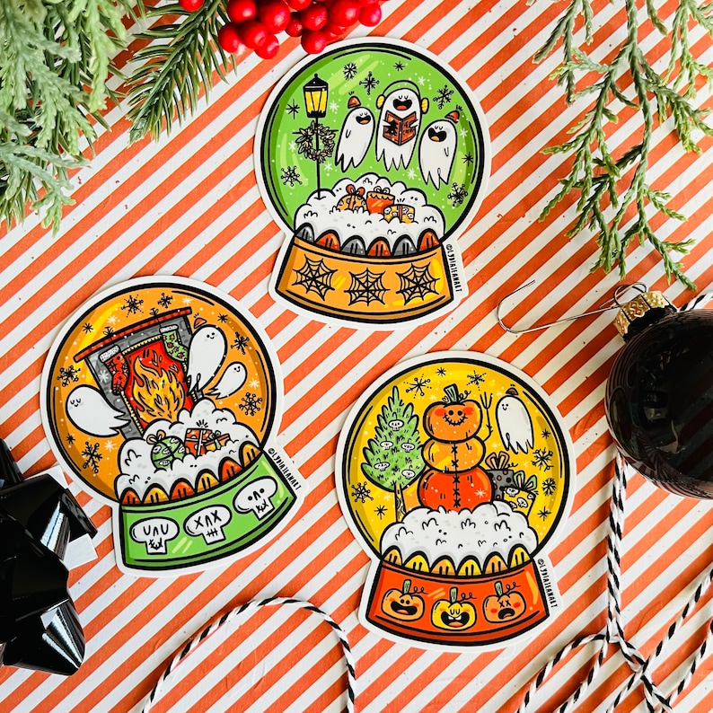 May include: Three snow globe ornaments with different holiday themes. The first snow globe features a fireplace with a ghost and a snowman. The second snow globe features a snowman with a pumpkin and a ghost. The third snow globe features a group of ghosts singing carols.
