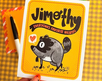 May include: A rectangular greeting card with a yellow background and a dotted border. The text reads Jimothy EVERYONES FAVORITE WEIRDO. A grey cartoon creature with a black mask and tail stands above a small red heart in a speech bubble.