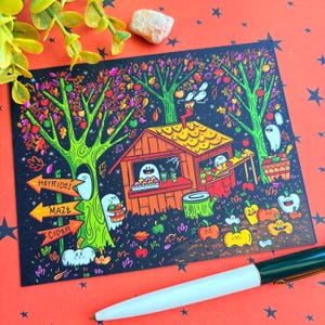May include: A Halloween-themed art print featuring a whimsical apple orchard scene with ghosts, pumpkins, and a small wooden stand. The print includes directional signs for hayrides, a maze, and cider. The color palette includes black, orange, green, and red.