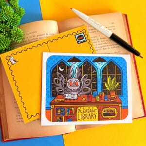 May include: A colorful illustration of an owl librarian behind a desk with the text "Point Pleasant Library." The image is on a white card, with a yellow envelope and a pen. A book is open in the background.