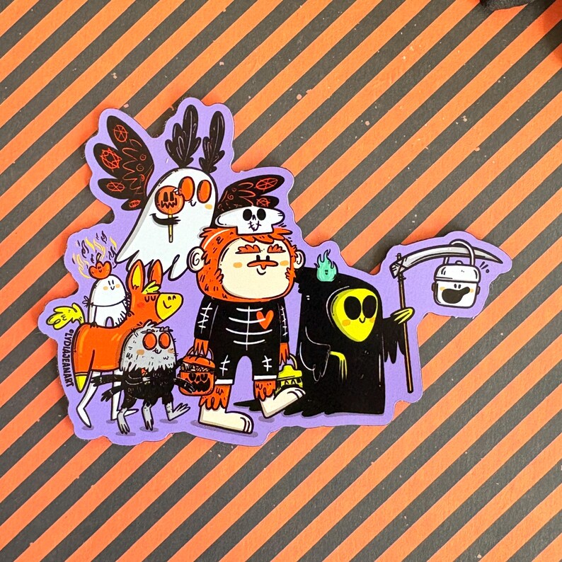 May include: A Halloween-themed sticker featuring a group of cartoon characters in costumes. The characters include a ghost, a skeleton, a grim reaper, and other creatures, all with a whimsical design. The sticker has a purple border and is set against an orange and black striped background.
