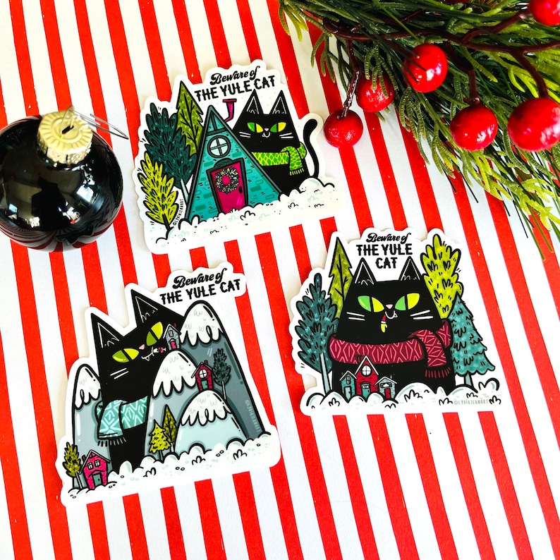 May include: Three black cat stickers with a winter holiday theme. Each sticker features a black cat wearing a red and black scarf and the text "Beware of the Yule Cat".