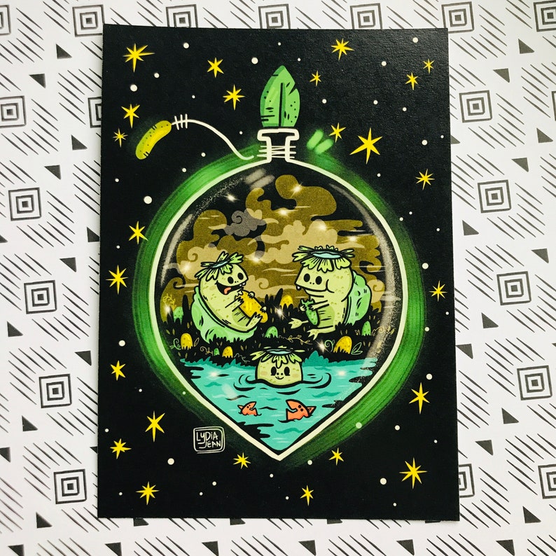 May include: A green glass orb with a glowing green rim, filled with a whimsical scene of two green creatures with flower crowns, sitting in a pond with a small creature swimming in the water. The orb is surrounded by a black background with yellow stars.
